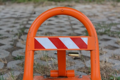 Photo of Barrier with No Parking sign on city street, closeup