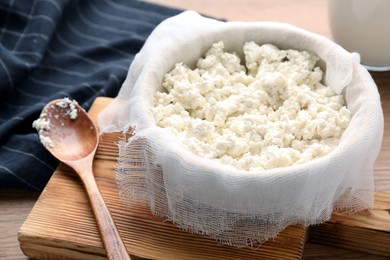 Delicious fresh cottage cheese on wooden table, closeup