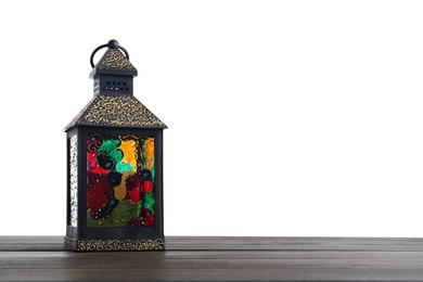 Decorative Arabic lantern on wooden table against white background