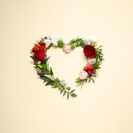Photo of Beautiful heart made of different flowers on beige background, flat lay. Space for text
