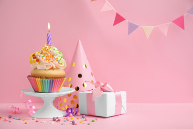 Composition with birthday cupcake on pink background
