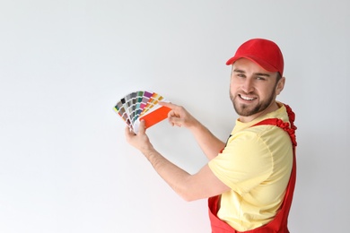 Photo of Male decorator with color palette on white background