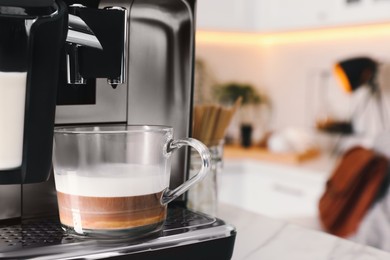 Photo of Modern coffee machine with cup of tasty drink in kitchen, space for text