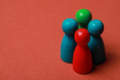 Photo of Colorful pawns on red background, closeup with space for text. Recruiter searching employee