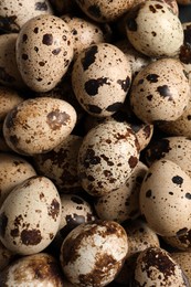 Many fresh quail eggs as background, closeup