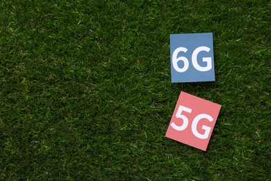 6G and 5G technology, Internet concept. Cards on green grass, flat lay. Space for text