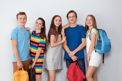 Group of teenagers on light background. Youth lifestyle and friendship