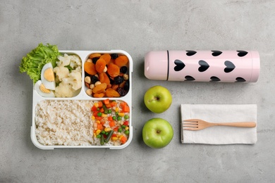 Flat lay composition with thermos and food on light grey table