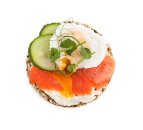 Crunchy buckwheat cake with salmon, poached egg and cucumber slices isolated on white