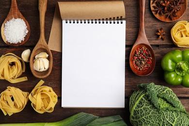 Notebook and different fresh products on wooden table, flat lay with space for text. Cooking Classes