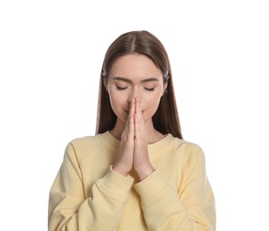 Woman with clasped hands praying on white background