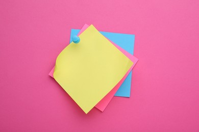 Colorful empty notes pinned on pink background