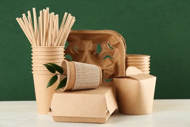 Disposable eco friendly products on white wooden table