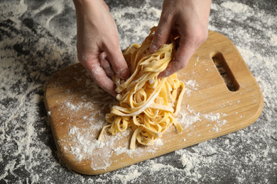 Woman preparing pasta at table, above view