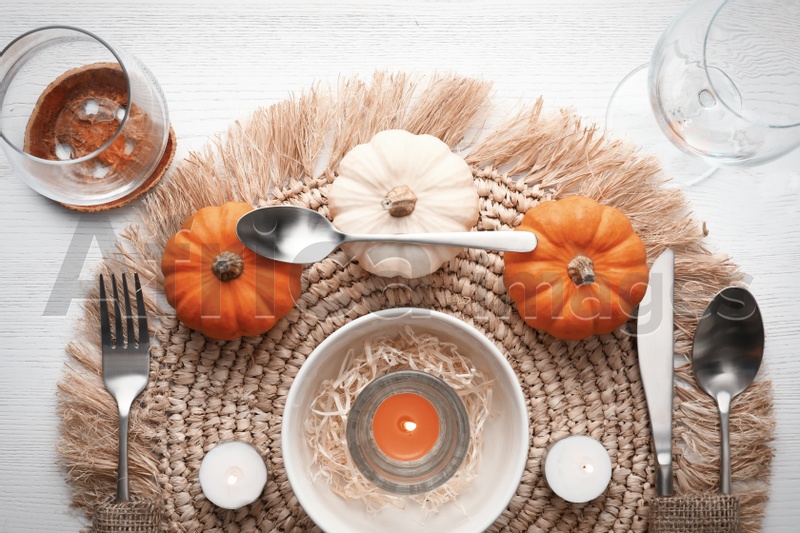 Photo of Autumn table setting with pumpkins on white wooden background, flat lay