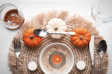 Autumn table setting with pumpkins on white wooden background, flat lay