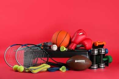 Photo of Set of different sports equipment on red background, space for text
