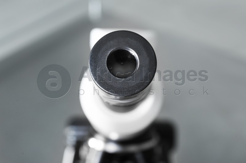 Closeup view of modern medical microscope on blurred background