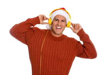 Emotional man with headphones on white background. Christmas music