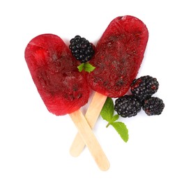 Delicious ice pops and fresh blackberries on white background, top view. Fruit popsicle