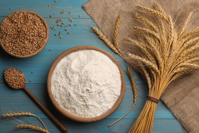 Flat lay composition with wheat flour on light blue wooden table