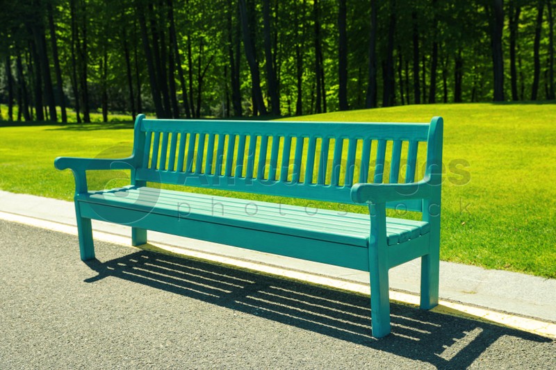 Photo of Beautiful view of light blue wooden bench in park