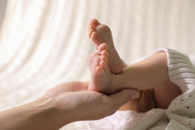 Mother and her newborn baby on bed, closeup