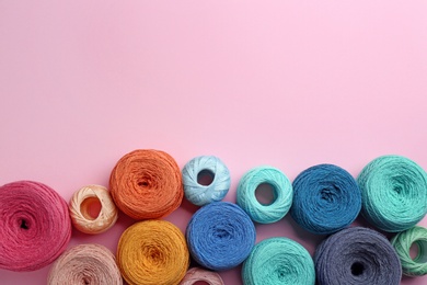 Clews of knitting threads on color background, flat lay with space for text. Sewing stuff
