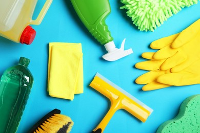 Flat lay composition with different car wash products on light blue background