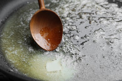 Melting butter in frying pan, closeup view