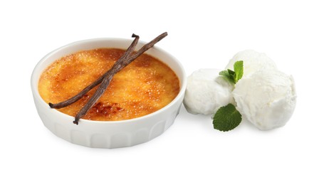 Delicious creme brulee with vanilla sticks, scoops of ice cream and mint on white background