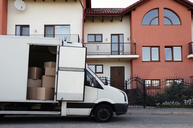 Van full of moving boxes near new house