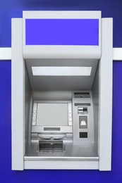 Photo of Modern color automated teller cash machine outdoors