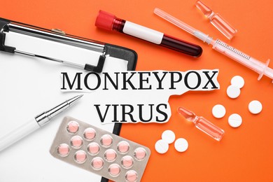 Flat lay composition with words Monkeypox Virus and medical supplies on orange background