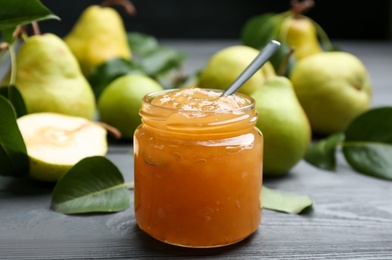 Delicious pear jam and fresh fruits on grey wooden table