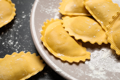 Photo of Ravioli on grey table, closeup view. Italian pasta