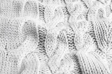 Photo of Grey knitted sweater as background, closeup view