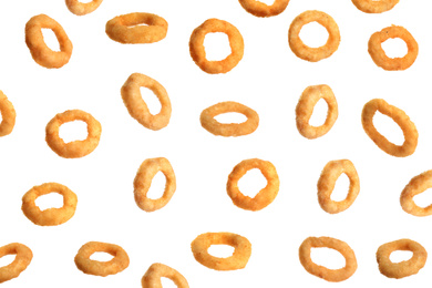 Fried onion rings falling on white background