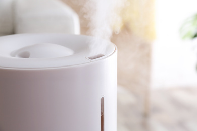 Modern air humidifier at home, closeup view. Space for text