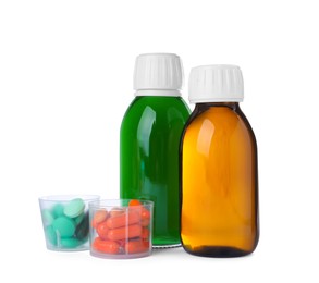Bottles of syrups with pills on white background. Cough and cold medicine