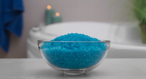 Bowl with bath salt on table in bathroom, closeup