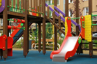Photo of Colourful slide outdoor playground for children in residential area