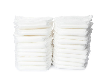 Photo of Stacks of baby diapers isolated on white