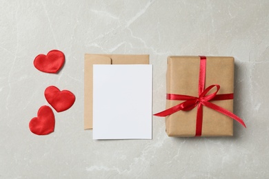 Flat lay composition with blank card on light background, space for text. Valentine's Day celebration