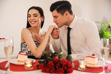 Happy couple having romantic dinner on Valentine's day in restaurant