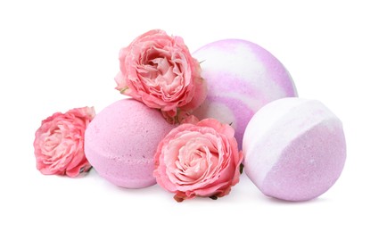 Fragrant bath bombs and rose flowers on white background