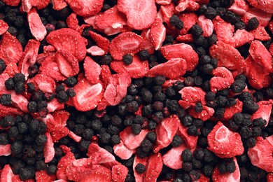 Photo of Closeup of freeze dried blueberries and strawberries as background, top view