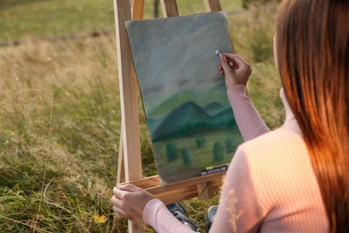 Woman drawing landscape with soft pastels outdoors, closeup