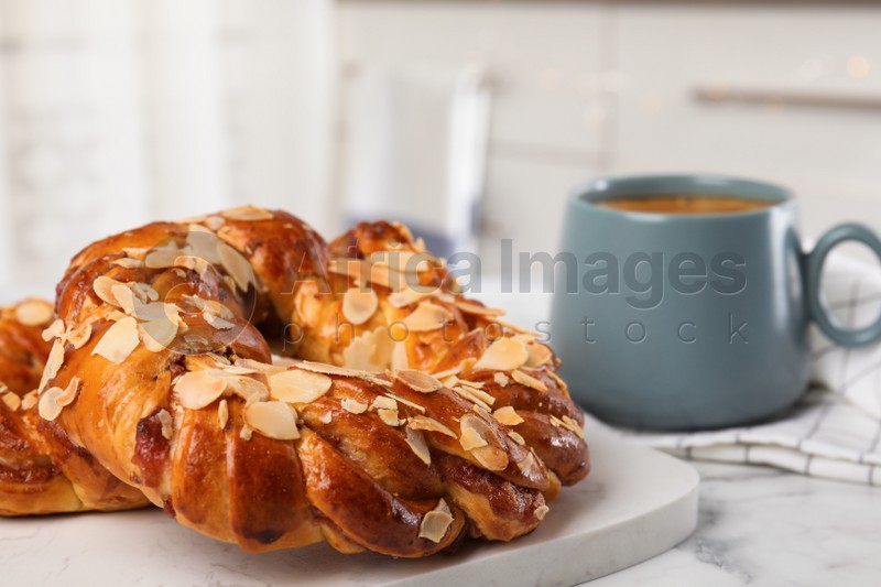 Delicious pastries and coffee on marble table, closeup