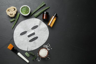 Photo of Flat lay composition with different cosmetic products and aloe on black table, space for text